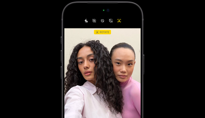 iPhone 18 Pro in Black, front-facing, showcasing two people with face tracking feature, demonstrates the Center stage front camera feature